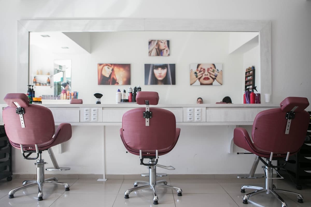 Colorful beauty salon interior with pink chairs